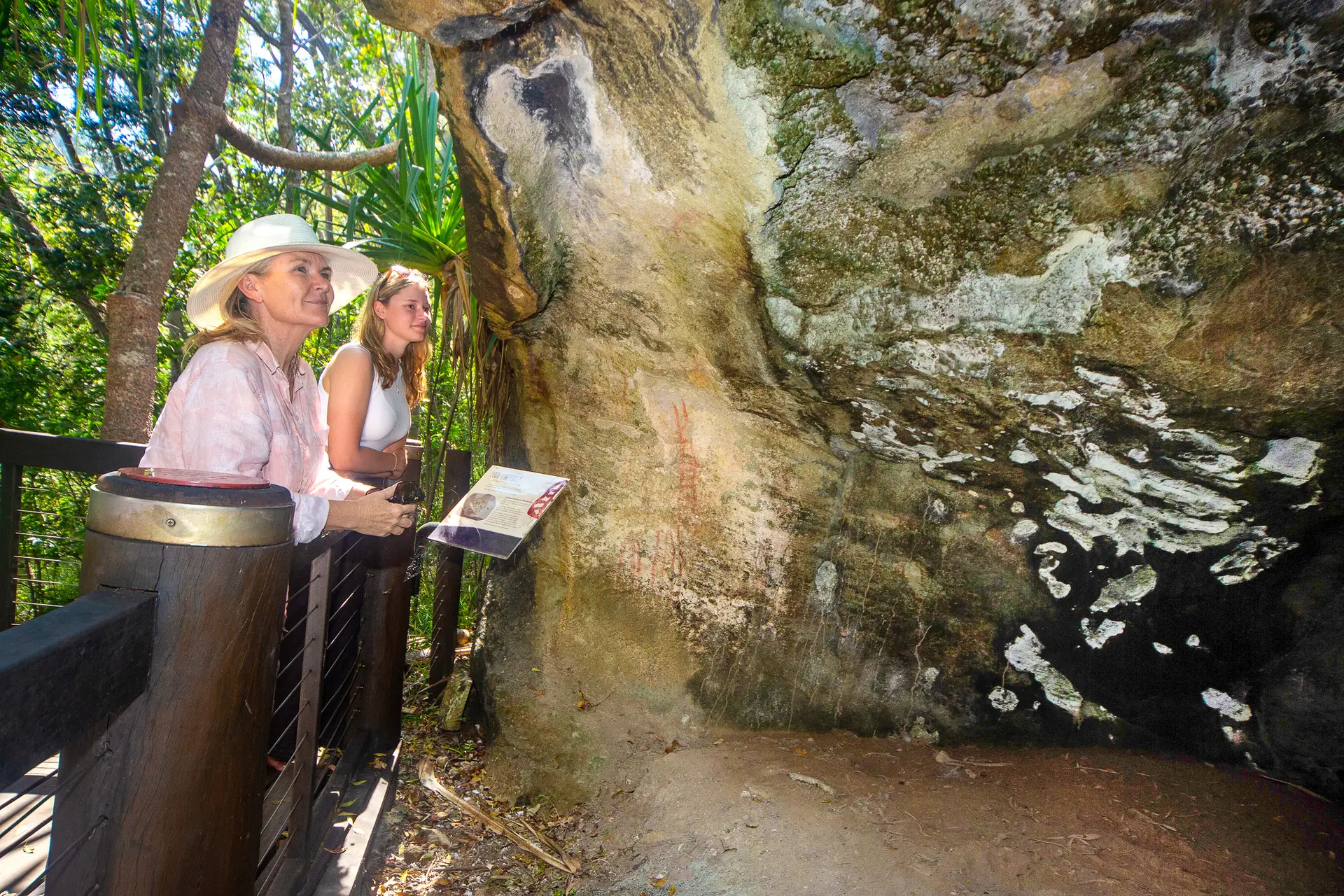 Girls admiring rock art in Nara Inlet, Ngaro people, culture, Whitsundays Hook Island