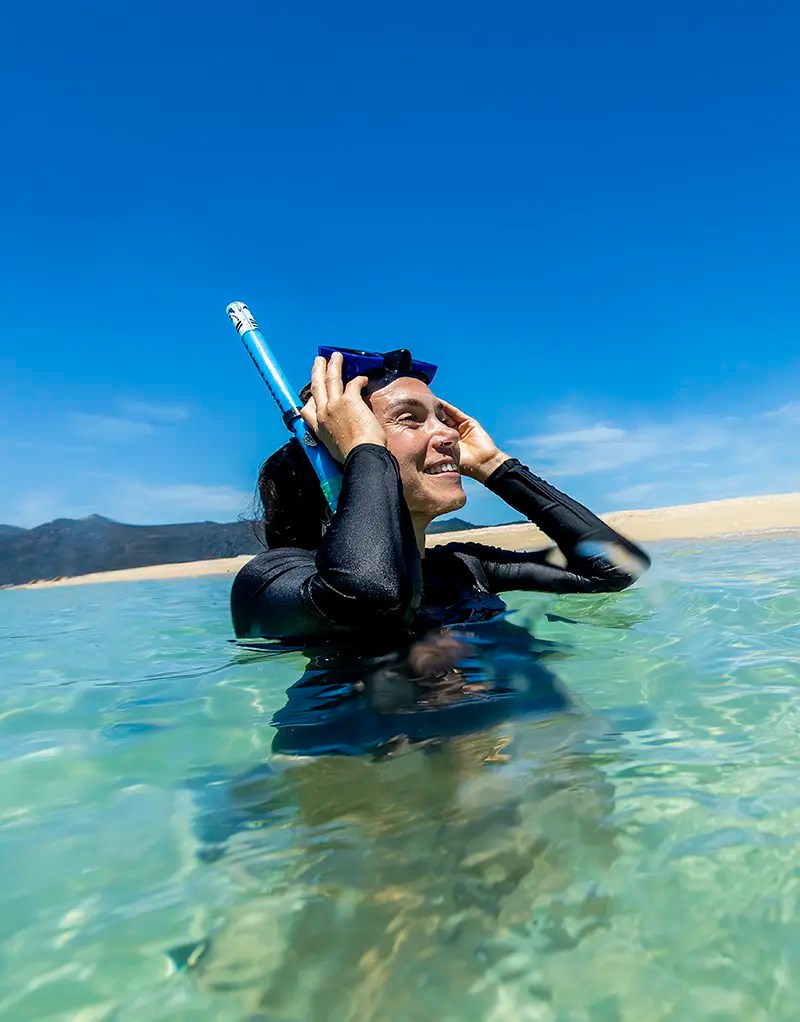 Iconic-Whitsunday-Adventures-Great-Barrier-Reef-Safety a man swimming in a body of water