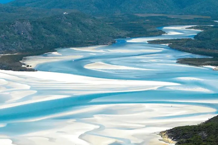a large body of water with a mountain in the background