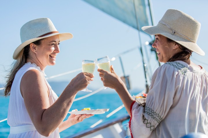Guests on Lady Enid enjoy a free glass of sparkling wine and antipasto on the sail home in the Whitsundays