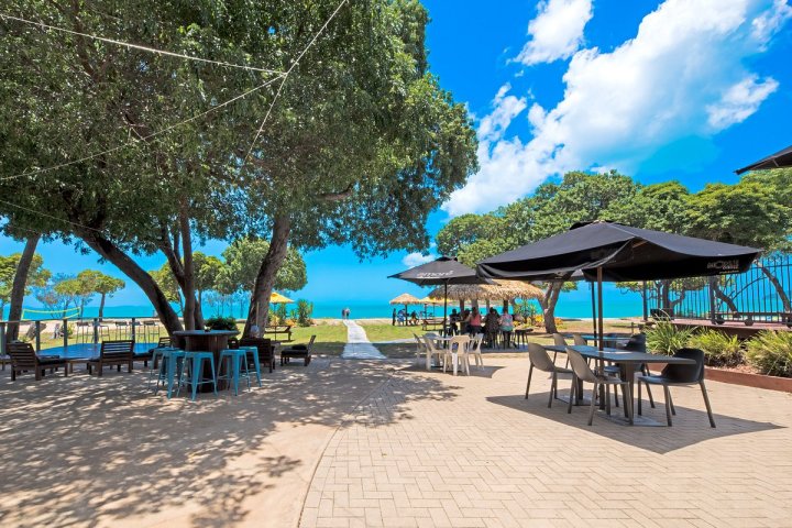 a group of lawn chairs sitting on top of a sandy beach